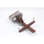 An early 20th century stereoscope slide viewer, of typical form, with adjustable slide holder and