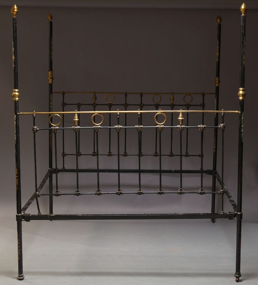 A Victorian black painted four poster double bed, with brass finials and fittings, the posts with