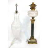 A late Victorian oil lamp, with brass fitting and glass reservoir, on fluted column with