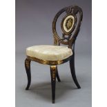 An ebonised and parcel gilt side chair, late 19th Century, the pierced oval back inset with verre