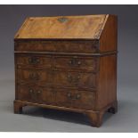 A Queen Anne walnut and feather banded bureau, the fall enclosing writing surface and an arrangement