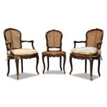 A pair of Louis XV beech and caned fauteuils, mid 18th Century, the cartouche shaped back centred by