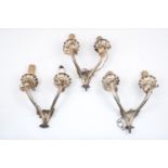 A set of three Edwardian twin branch electrical wall sconces, designed with foliate scroll motifs,