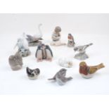 A group of eight small Royal Copenhagen porcelain figure groups depicting various birds, with one