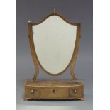 A George III mahogany and boxwood strung toilet mirror, the shield shaped plate above a three drawer