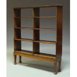 A George III style mahogany open book case, 20th Century, the top surmount with three quarter