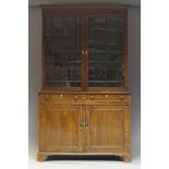 A George III mahogany bookcase, the moulded cornice above two astragal glazed doors enclosing