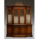 A George II style breakfront bookcase by Wade, late 20th Century, with pierced swan neck pediment,