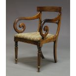 A Regency rosewood bar back armchair, with curved scrolling arms, above needlework upholstered