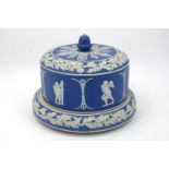 An English blue jasperware cheese bell and base, 19th century, decorated with a frieze of amorini in