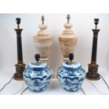 A pair of toleware column table lamps, 60cm high, together with a pair of blue and white Chinese