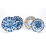 An 18th century Dutch Delft Ware charger, decorated with a blue and white naturalistic design,