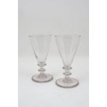 A pair of George III ale glasses, with conical bowls and knopped stems, each 19.5cm high (2)Please
