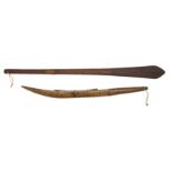 A Solomon Island paddle club, with a fine line moulding to the tip, 114cm long, together with a club