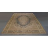 A Persian style carpet, of recent manufacture, with central ivory medallion medallion on faded green