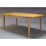 An oak extending dining table, of recent manufacture, the rectangular top with two additional