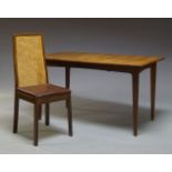 A teak extending dining table, c.1960, the rectangular top, with one pull out leaf beneath, raised