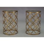 A pair of gilt metal side tables, of recent manufacture, with circular glass tops on cylindrical