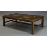 A large reverse printed glass and brass bound coffee table, c.1960, the glass top decorated with