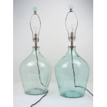 A pair of modern table lamps, each designed with clear blue glass bodies, of tapering form, with