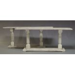 A pair of white painted console tables, of recent manufacture, the rectangular tops on turned and