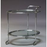 An Art Deco chrome and glass two tier trolley, c.1940, with two oval glass and mirrored tiers, on