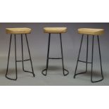 A set of three contemporary bar stools, with shaped oak seats, on black anodized steel rod frame (