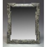 A contemporary wall mirror, of recent manufacture, with raised geometric and reverse painted border,