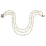 A cultured pearl choker necklace, composed as a triple row of cultured pearls to a diamond-set