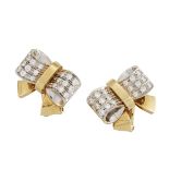 A pair of diamond clip earrings, by Pomellato, of stylised bow design, the shoulders of each bow