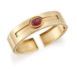 A ruby single stone cuff bangle, by Bulgari, with double hinged hoop, the cabochon ruby in collet
