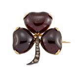 A Victorian garnet and diamond shamrock brooch, each leaf designed as a heart-shaped cabochon garnet