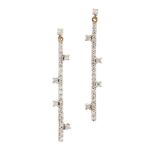 A pair of diamond line drop earrings, each designed as a single diamond suspending an articulated