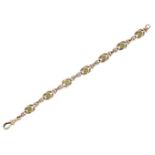 An Edwardian 9ct gold and peridot bracelet, designed as a series of reef knots with collet-set