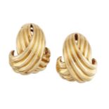 A pair of crossover ear clips, by Hermes, designed as rounded, reeded arcs to clasp fittings, the