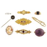 A group of jewellery, comprising: a 15ct gold, cushion shaped garnet single stone brooch, Chester