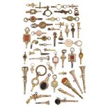 A collection of pocket watch keys of various designs, including a pistol and a rotating seal,