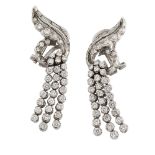 A pair of diamond ear clips, of stylised cluster scroll design with graduating rows of circular