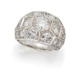 A diamond cluster ring, of brilliant-cut diamond 'honeycomb' set bombé cluster design to pavé