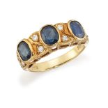 A sapphire and diamond half-hoop ring, composed of a line of three oval sapphire collets with