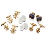 Three pairs of cufflinks, comprising: two pairs of ship's wheel and anchor design with hinged reeded