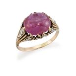 A pink sapphire single stone ring, the oval cabochon pink sapphire, weighing approximately X.XX