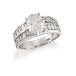 A diamond oval single stone ring, with rectangular and circular cut diamond half hoop shoulders, the