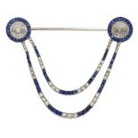 An Art Deco rock crystal, sapphire and diamond jabot pin, each terminal composed of a circular