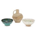 Three Islamic pottery vessels, including an unglazed and stamped handled vase, an incised green