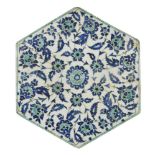 An Iznik style tile, Turkey, early 20th century, of hexagonal form, underglaze painted in