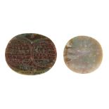 A carved red and green jasper talismanic stone, Iran, 19th century, and another uncarved of the same