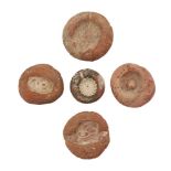 Five Egyptian terracotta bead and ring moulds, Amarna Period, 14th century BC., largest 3.7cm. diam.