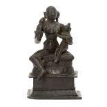 A bronze figure of Yashoda with Krishna, South India, 19th century, on a tiered rectangular base,