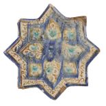 A Kashan star-shaped tile with inscription, Iran, 12th century, underglaze decorated in lustre and